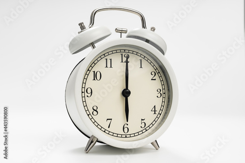 retro alarm clock on a white background. concept of early morning ascents.