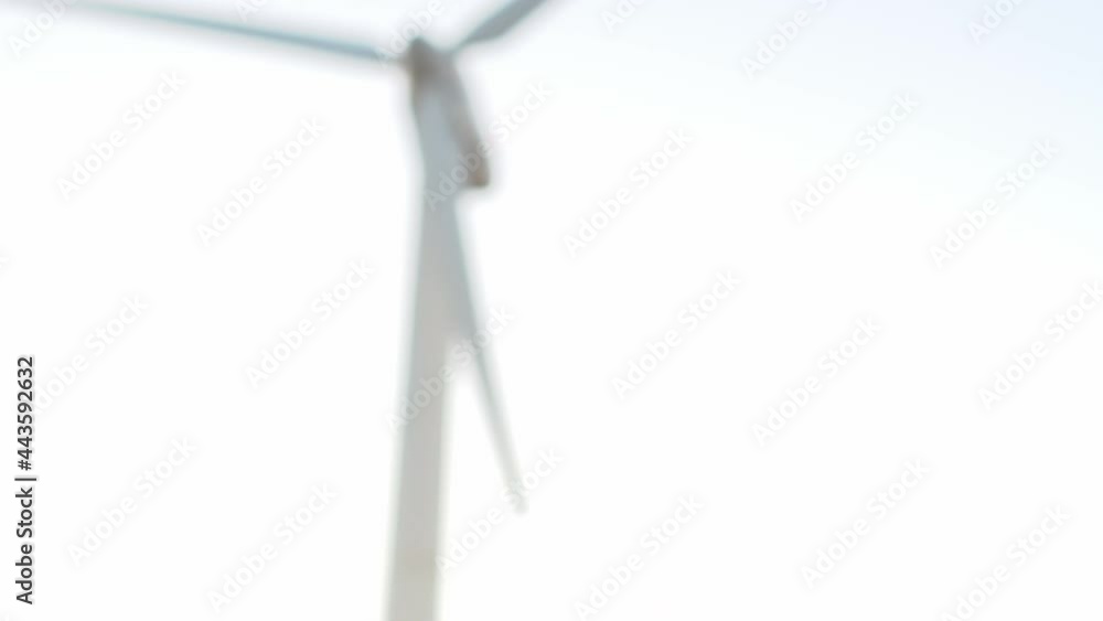 Closeup of business handshake of men against the background of modern windmill. Concept of successful cooperation Closeup of business handshake of men against the background of modern windmill. Concept of successful cooperation
