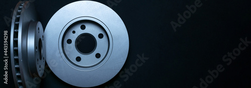 Silent blocks. New metal car part. Auto motor mechanic spare or automotive piece isolated on dark background. Automobile engine service with space for text.