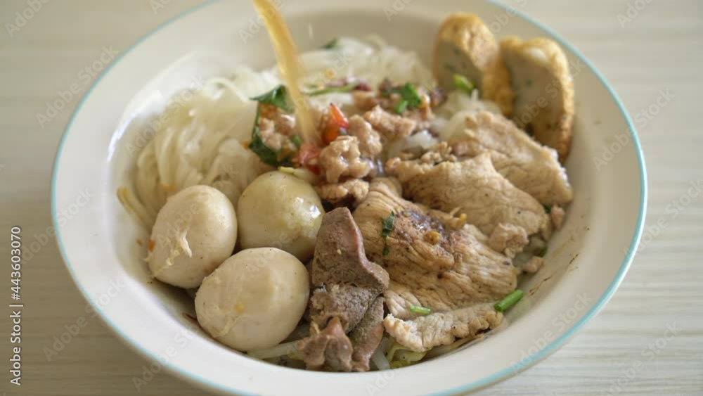 noodles with pork and meatballs in spicy soup or Tom yum noodles in Asian style noodles with pork and meatballs in spicy soup or Tom yum noodles in Asian style