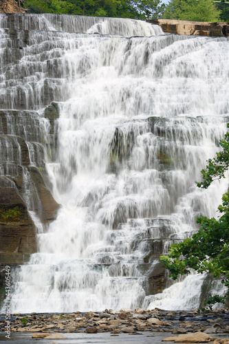 Ithaca Falls on a sunny day. Ithaca Falls is a waterfall located within the city of Ithaca, New York. Slow motion has been applied.