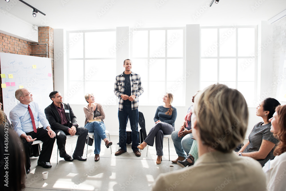 Fototapeta premium Guy standing and speaking in a circle