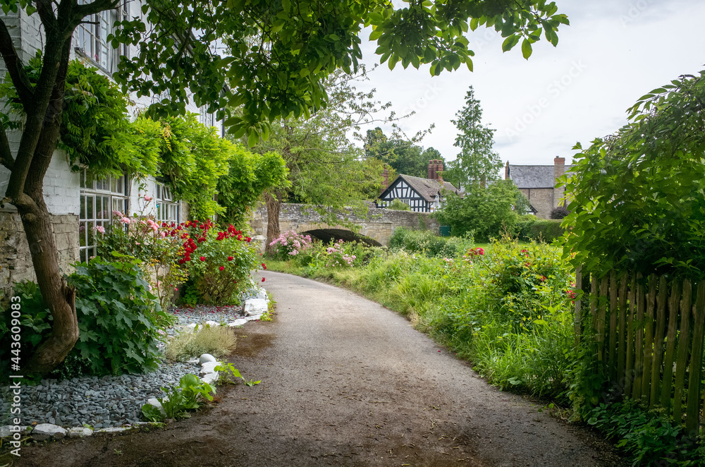path in the park with timber frame house