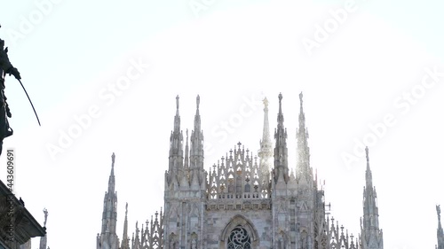 Aerial drone footage view of famous statue on cathedral Duomo in Milan Italy  // no video editing
