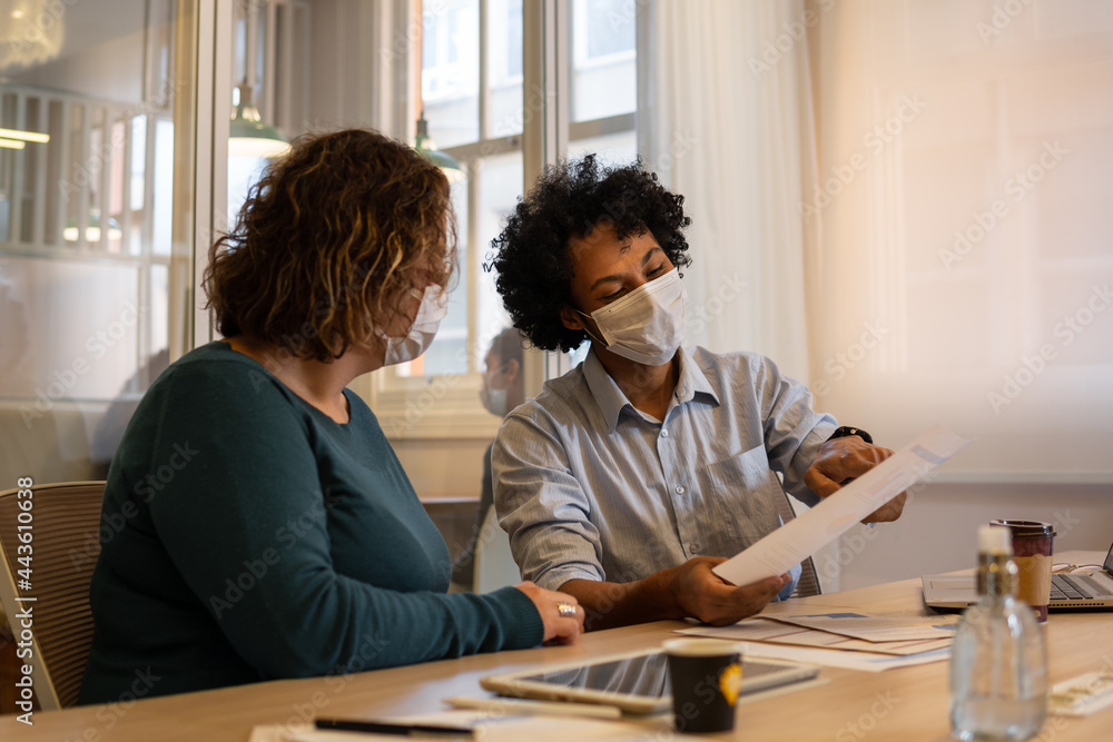african american man showing plans and corporate results in meeting room. african american man showing plans and corporate results in meeting room.