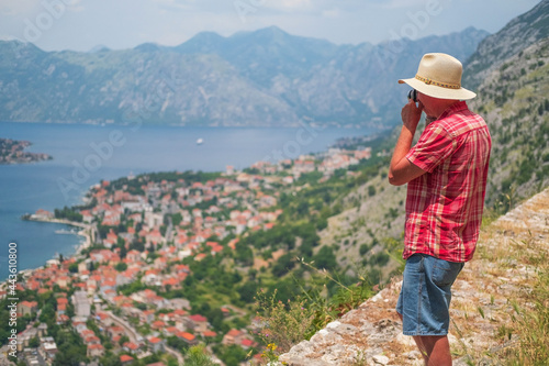 Man stands the beautiful nature landscape and makes photos, Montenegro.