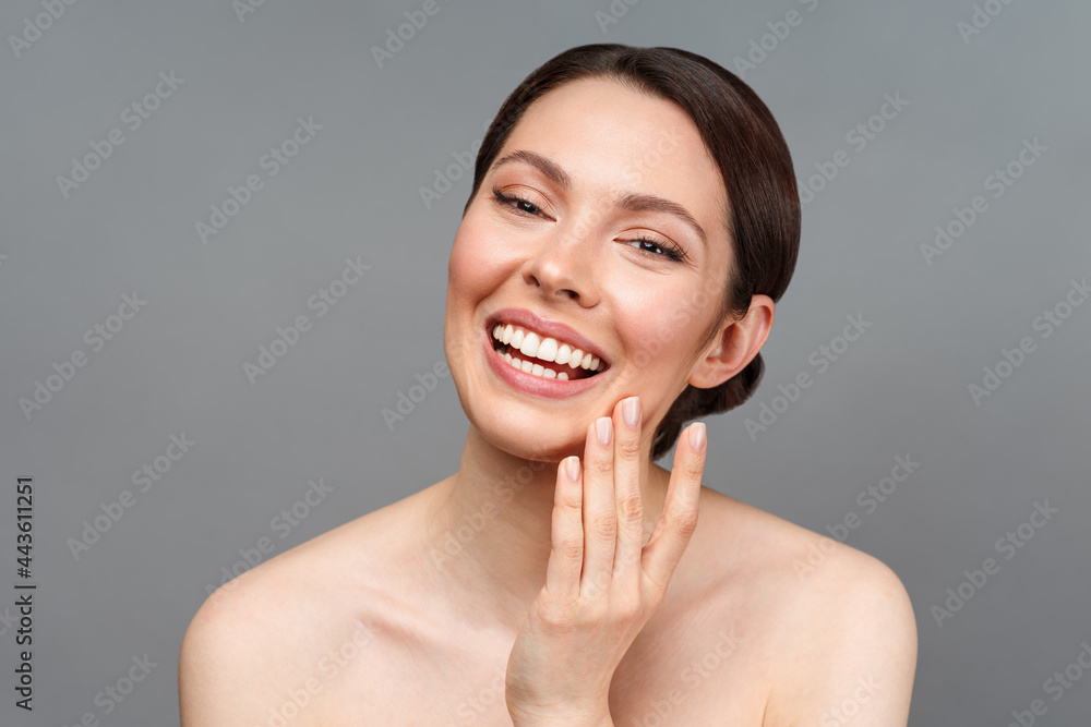 Young beautiful woman with perfect skin, touching her face and smile. Cosmetology, beauty and spa concept. Young beautiful woman with perfect skin, touching her face and smile. Cosmetology, beauty and spa concept.