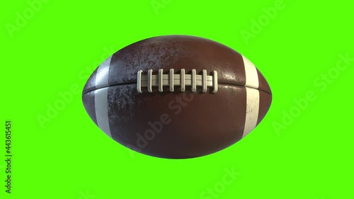 3D American Football spinning on the spot with a green screen. Side on view of a rotating brown and white ball going in a straight line. Perfect for perimeter advertising with the ball's side profile.