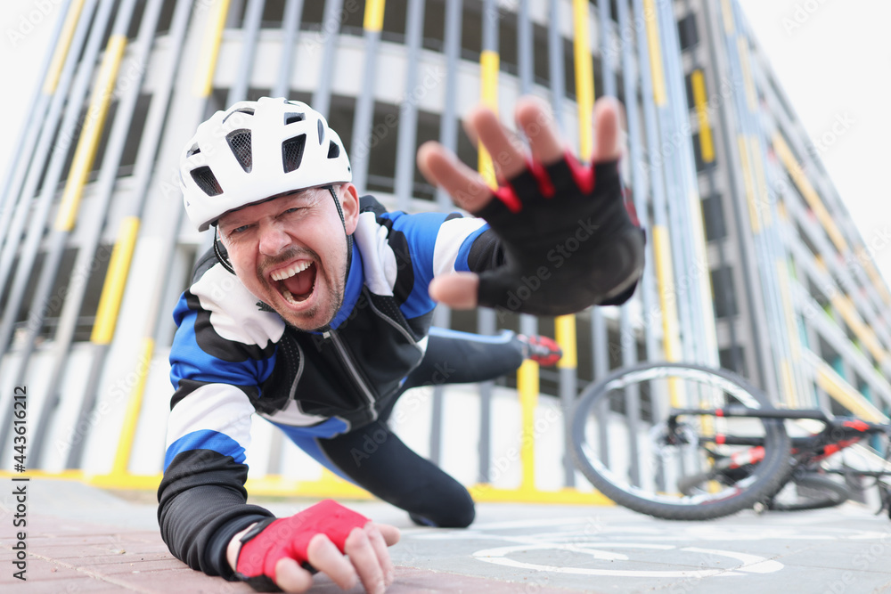 Cyclist screaming falls off bike onto asphalt Cyclist screaming falls off bike onto asphalt