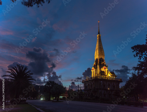 panorama view colorful cloud above pagoda of Chalong pagoda in twilight..beautiful architecture pagoda of Chalong temple in the night..colorful cloud scape sky sunset.