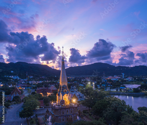 .aerial panorama view colorful cloud above pagoda of Chalong pagoda in twilight..beautiful architecture pagoda of Chalong temple in the night..colorful cloud scape sky sunset.