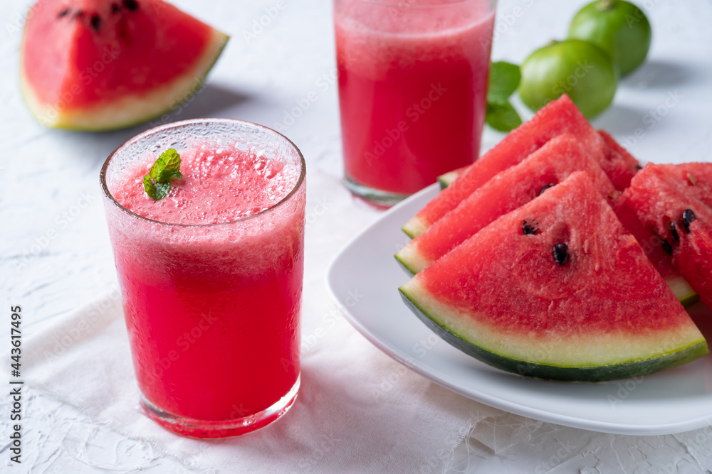 Watermelon smoothie topping with fresh mint leaves on wood background Watermelon smoothie topping with fresh mint leaves on wood background