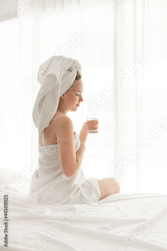 Morning. Girl asleep, woke up and lies on bed. Relaxation, slow life, well-being, self-care, mental health and relaxation. Meditation in bed in the morning.