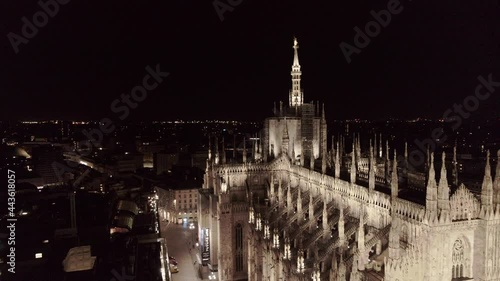 Aerial drone footage of famous statue on cathedral Duomo in Milan Italy by night // no video editing
