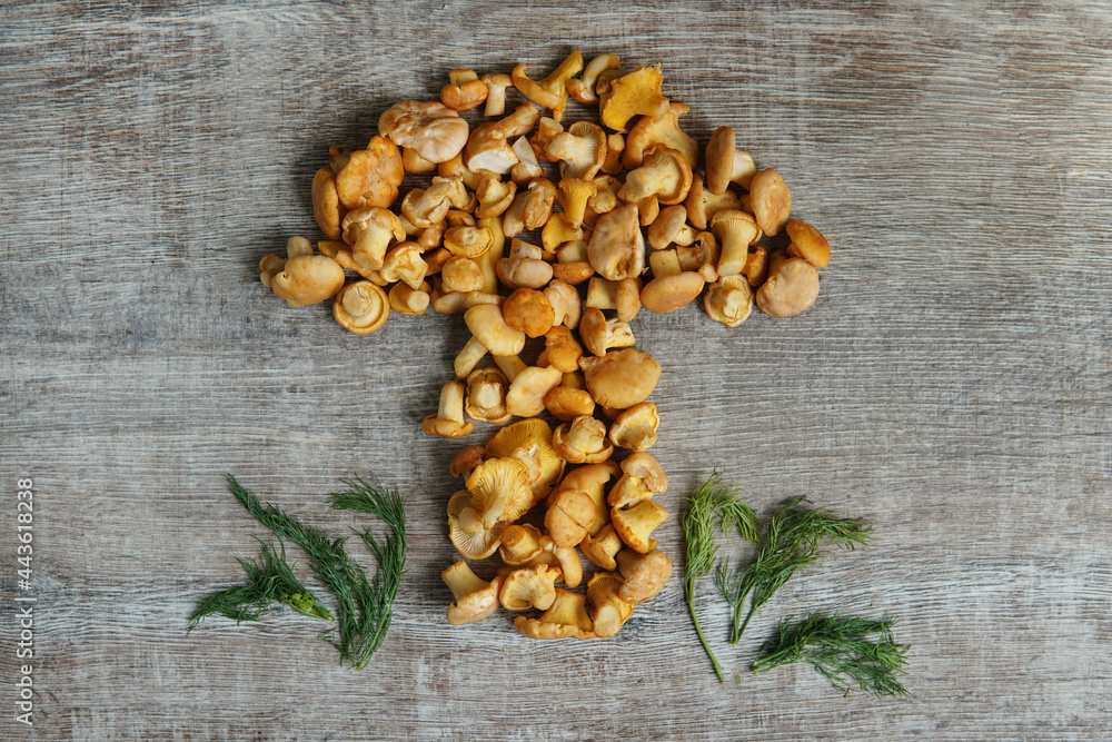 chanterelle mushrooms in the shape of a mushroom concept dill on a wooden table chanterelle mushrooms in the shape of a mushroom concept dill on a wooden table