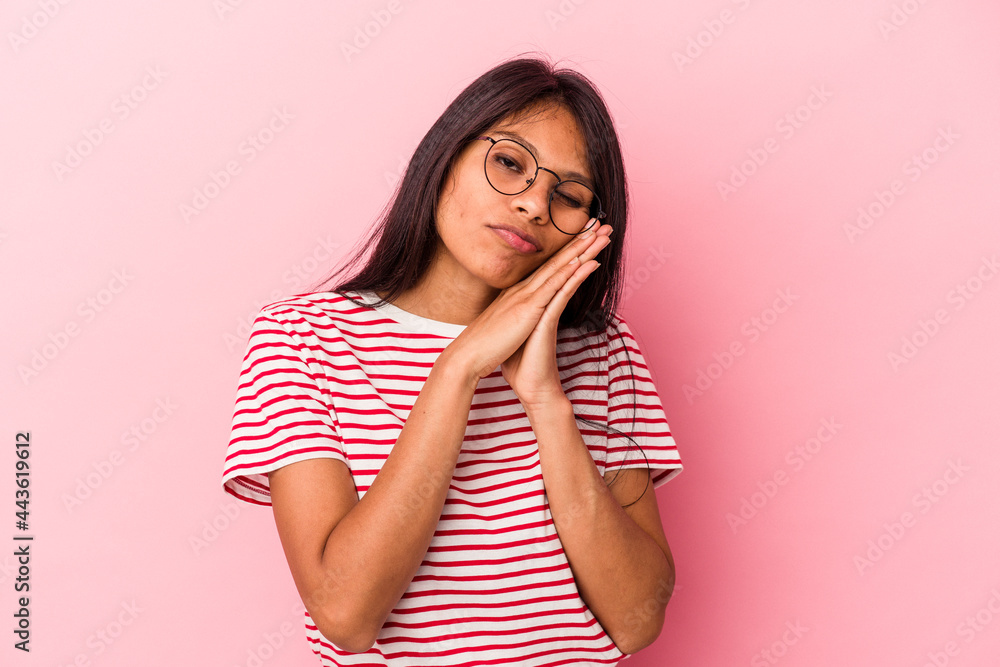 Young latin woman isolated on pink background yawning showing a tired gesture covering mouth with hand. Young latin woman isolated on pink background yawning showing a tired gesture covering mouth with hand.