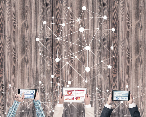 Top view of businesspeople sitting at table and using gadgets