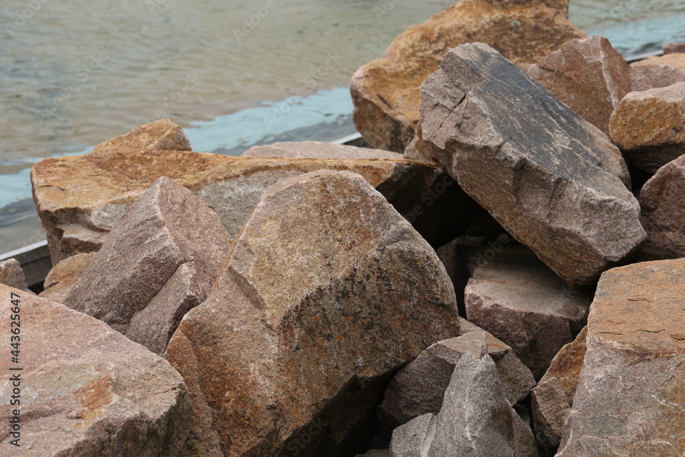 Piles of natural stones by the lake