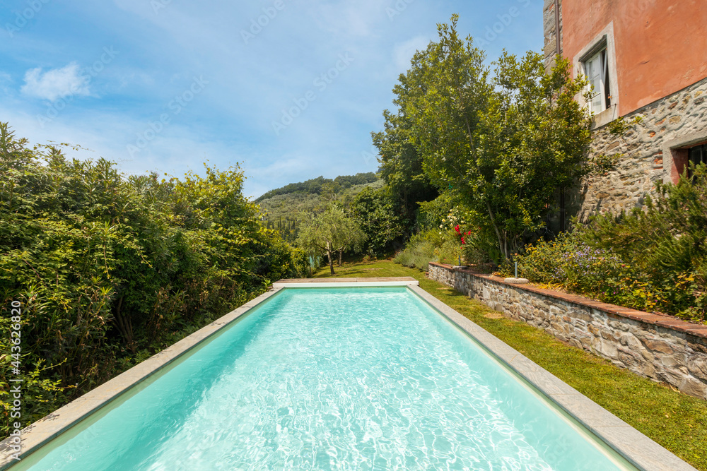 Exterior of Italian villa in Tuscany with swimming pool.