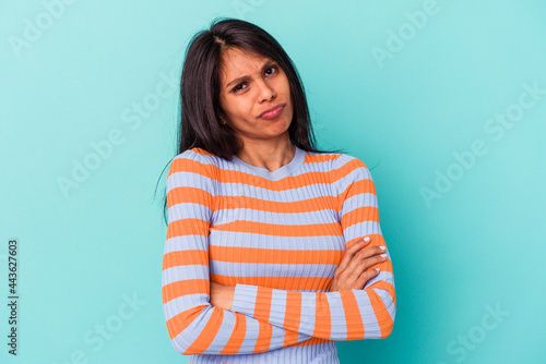 Young latin woman isolated on blue background unhappy looking in camera with sarcastic expression.