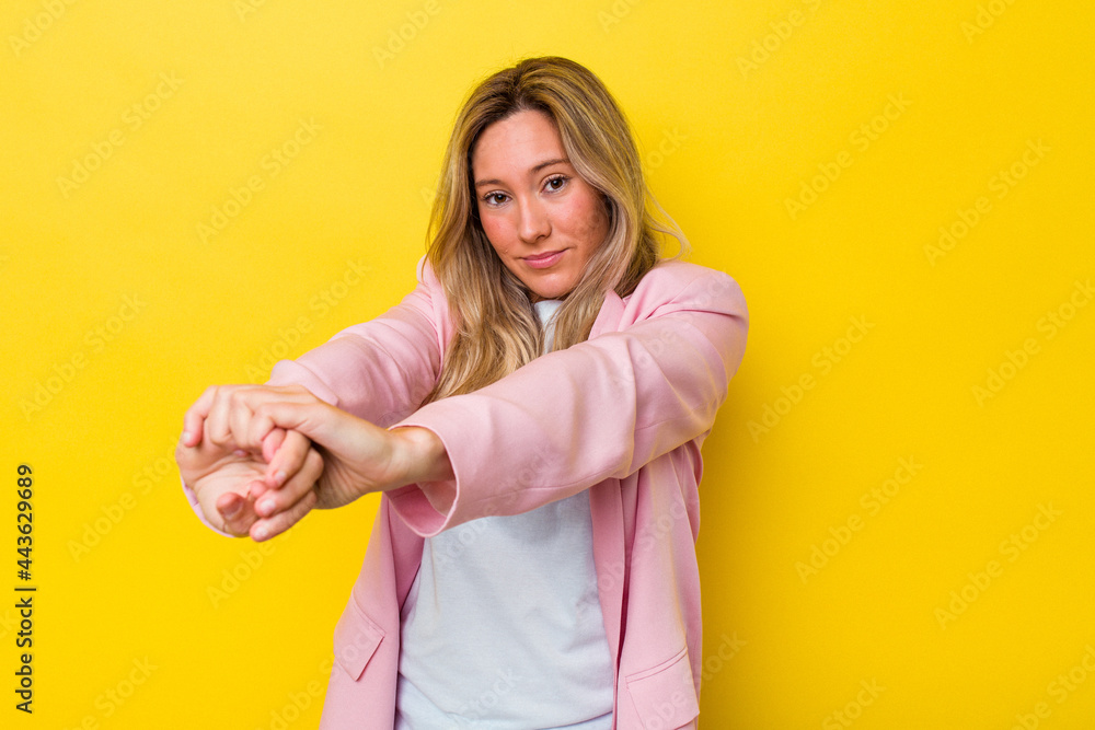 Young australian woman isolated stretching arms, relaxed position. Young australian woman isolated stretching arms, relaxed position.