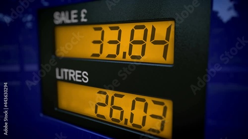 UK fuel dispenser display with slow zoom-in motion. Real-time fueling process. British Pound Sterling currency.