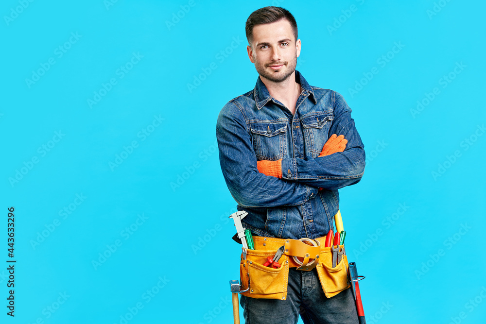 Portrait of confident handsome male construction worker with crossed arms and copy space Portrait of confident handsome male construction worker with crossed arms and copy space