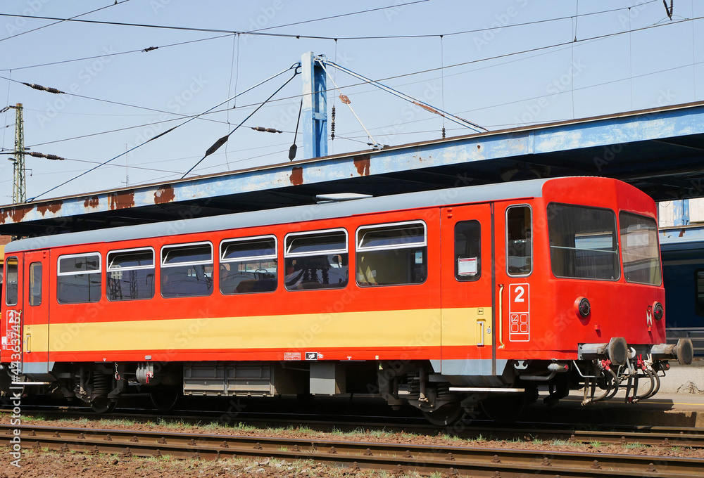 Red passenger carriage at the railway station
