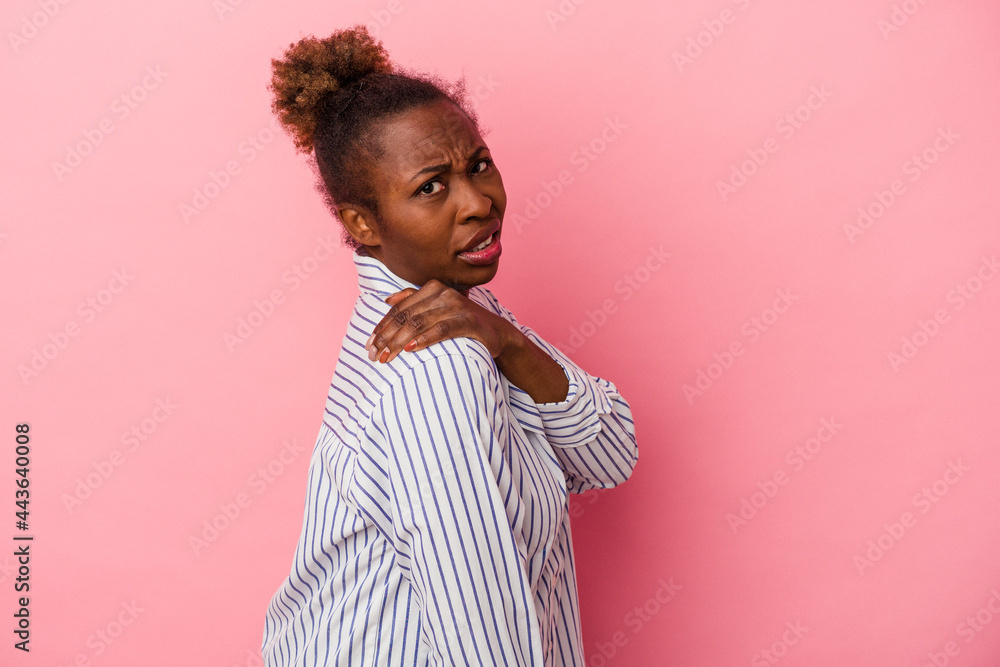 Young african american woman isolated on pink background having a shoulder pain.