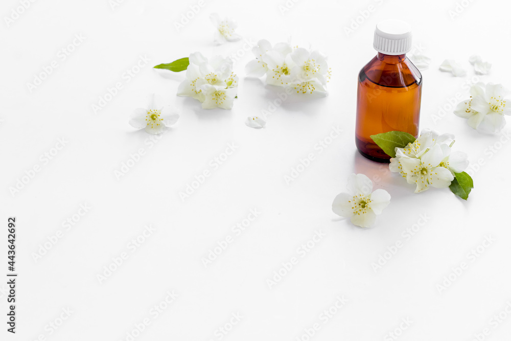 Bottle of fragrant jasmine essential oil. Close up Bottle of fragrant jasmine essential oil. Close up