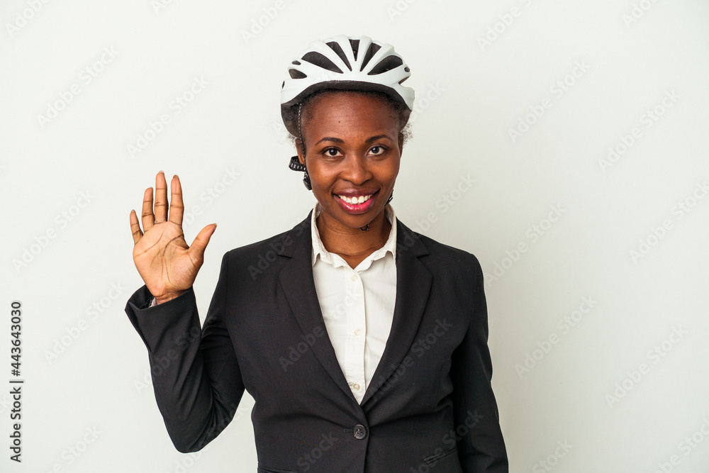 Young business african american woman wearing a bike helmet isolated on white background smiling cheerful showing number five with fingers. Young business african american woman wearing a bike helmet isolated on white background smiling cheerful showing number five with fingers.