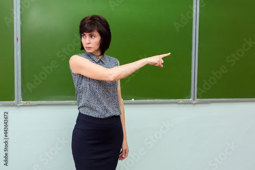 Foto The teacher at the blackboard during the lesson expels student from the class
