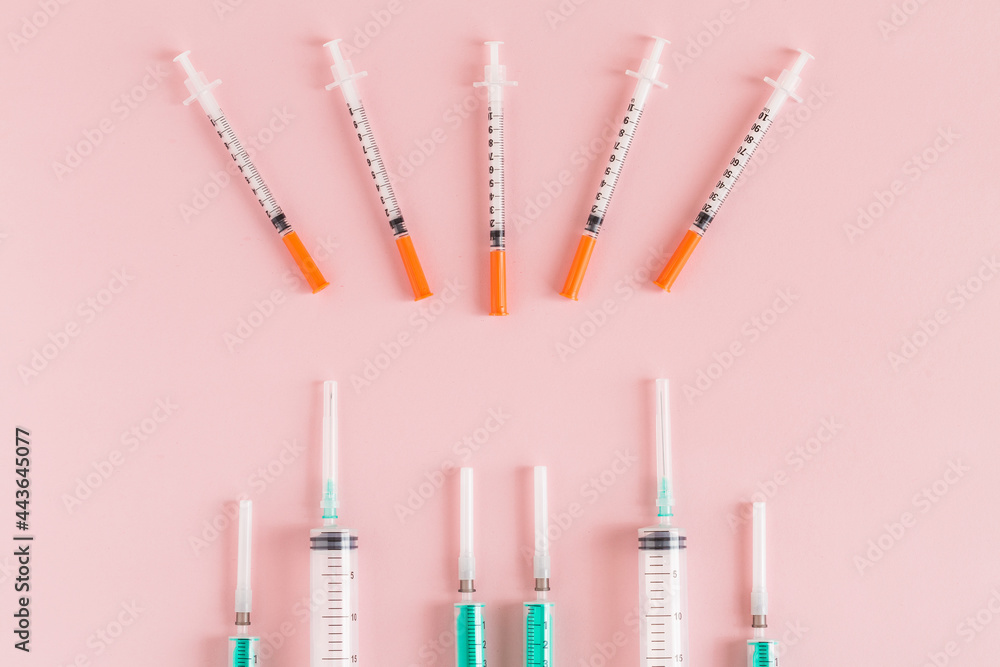 Several syringe on pink table prepared for injection in hospital Several syringe on pink table prepared for injection in hospital