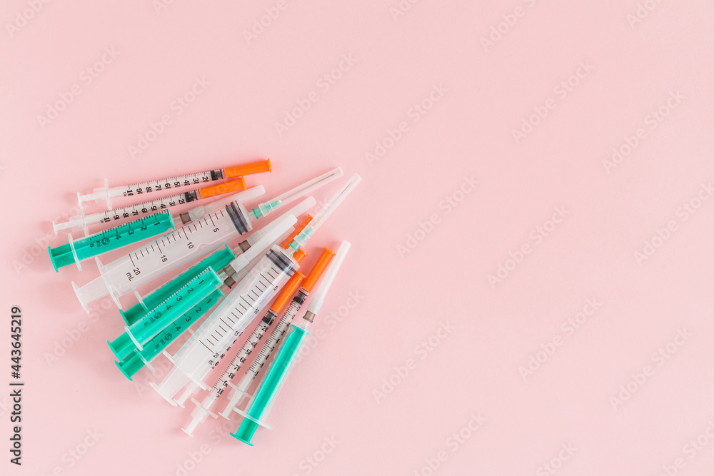 Several syringe on pink table prepared for injection in hospital Several syringe on pink table prepared for injection in hospital