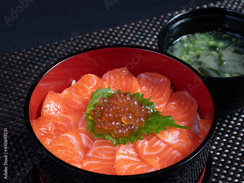 Salmon sashimi and salmon roe with rice bowl or donburi in Japanese style food.