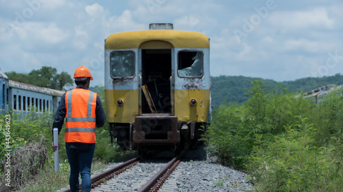 train on the railway. worker , engineer walk on railways with Bogie on background.