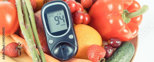 Glucose meter for checking sugar level and healthy fruits with vegetables. Diabetes and source minerals and vitamins