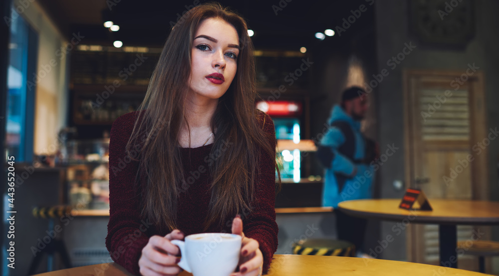 Calm woman drinking coffee in cafeteria Calm woman drinking coffee in cafeteria