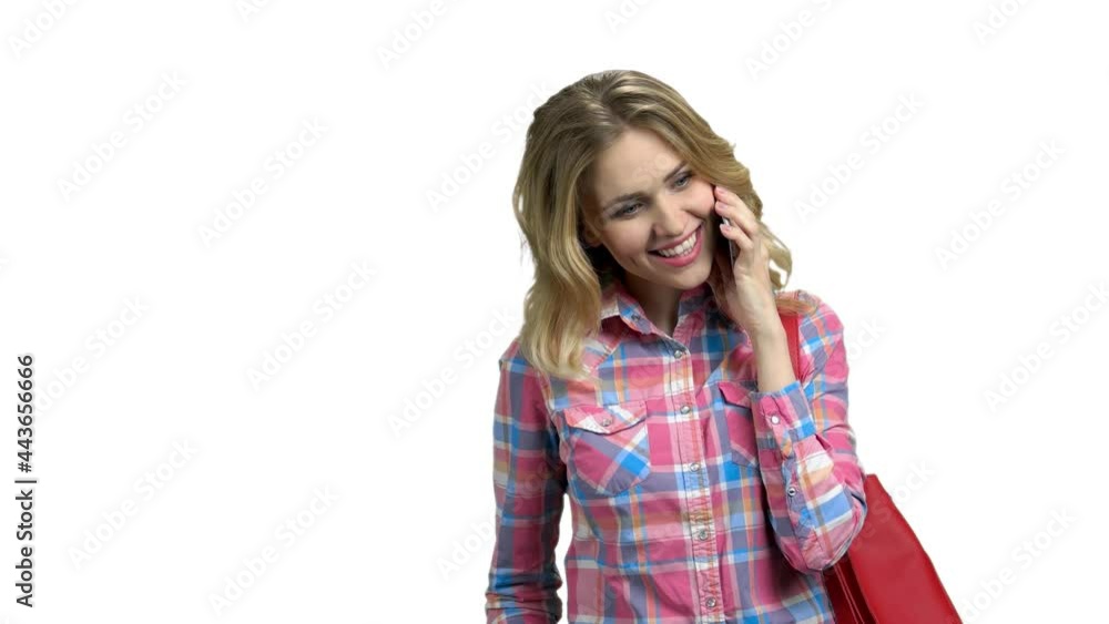 Young positive woman using phone on white background. Young positive woman using phone on white background.