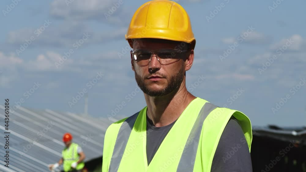Solar power station employee looking at camera Solar power station employee looking at camera