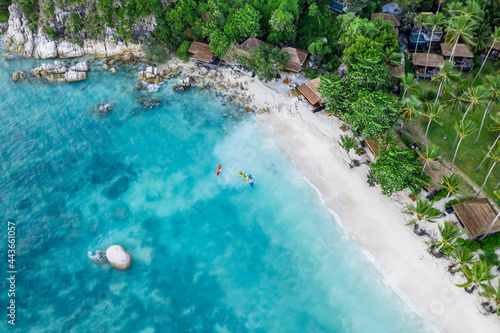 Tourists kayaking on clear blue tropical water near the beach with copy space, Koh Tao, Thailand, South East Asia