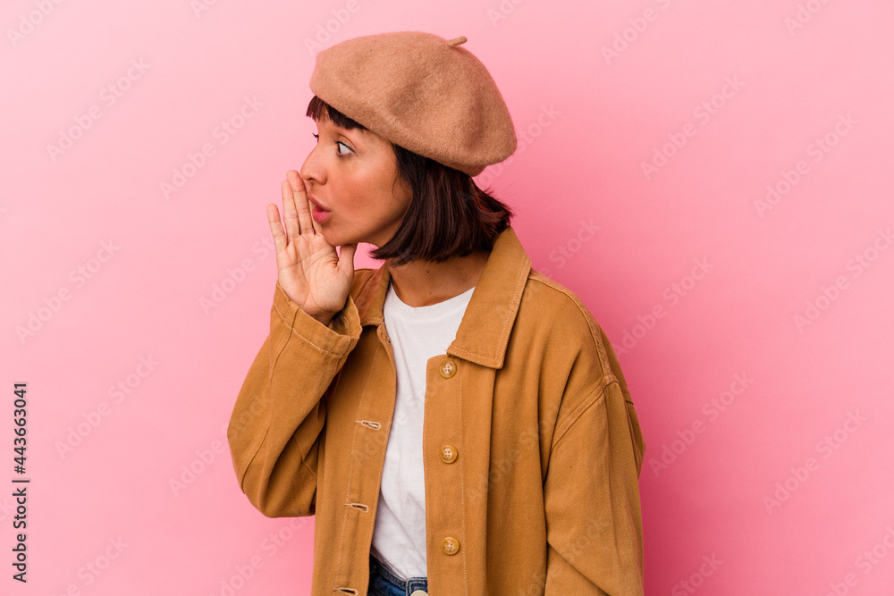Young mixed race woman isolated on pink background is saying a secret hot braking news and looking aside Young mixed race woman isolated on pink background is saying a secret hot braking news and looking aside