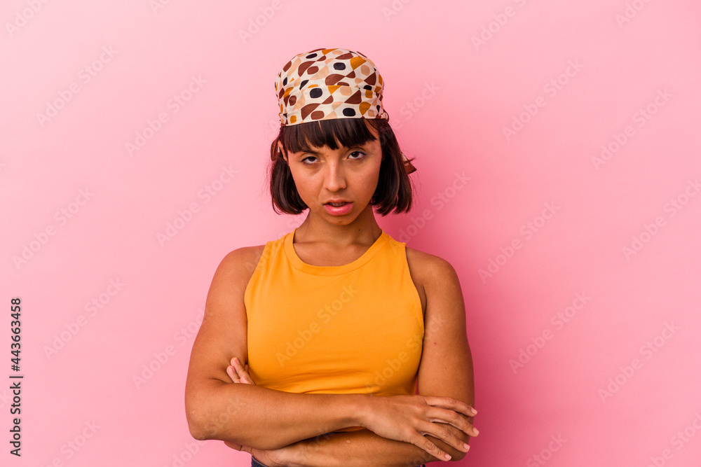 Young mixed race woman isolated on pink background who is bored, fatigued and need a relax day. Young mixed race woman isolated on pink background who is bored, fatigued and need a relax day.