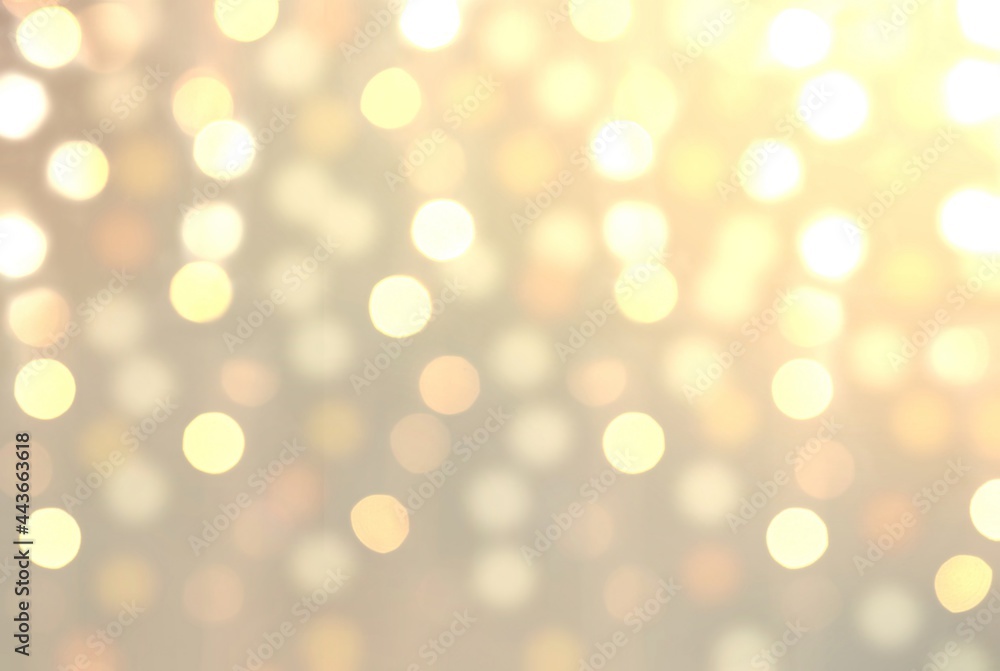 Glare bokeh effect pastel holiday decorative background. Champagne color.