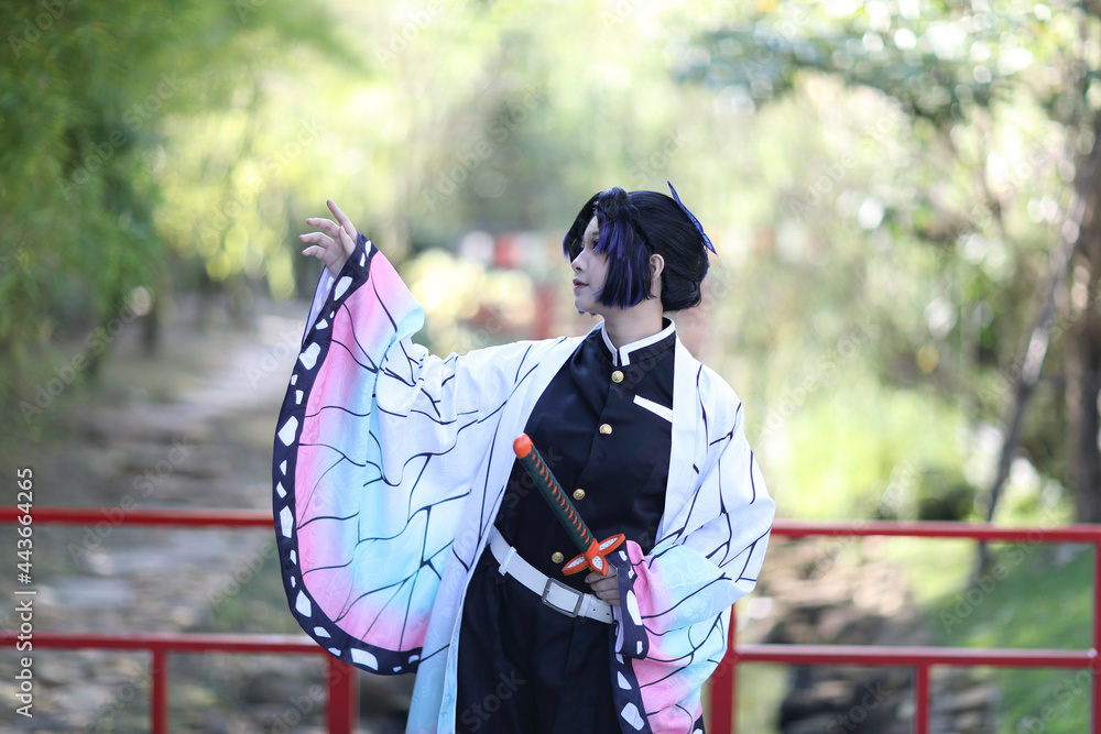 Japan anime cosplay portrait of girl with comic costume with japanese theme garden