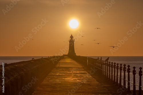 Tynemouth Pier and the Lighthouse with a beautiful vibrant sunrise