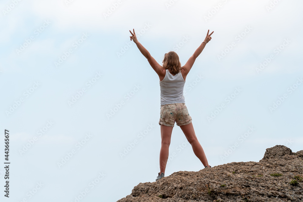 silhouette of girl standing on cliff side with open arms silhouette of girl standing on cliff side with open arms