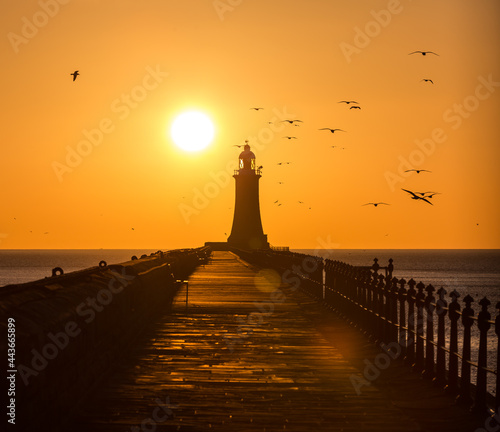 Tynemouth Pier and the Lighthouse with a beautiful vibrant sunrise photo