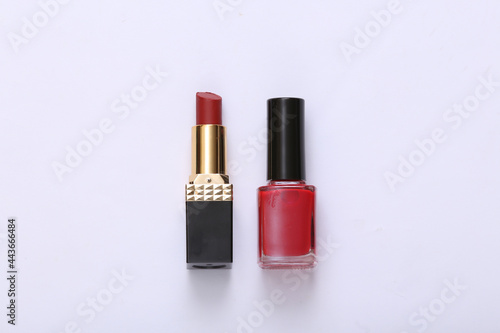 Bottle of nail polish and lipstick on white background © splitov27
