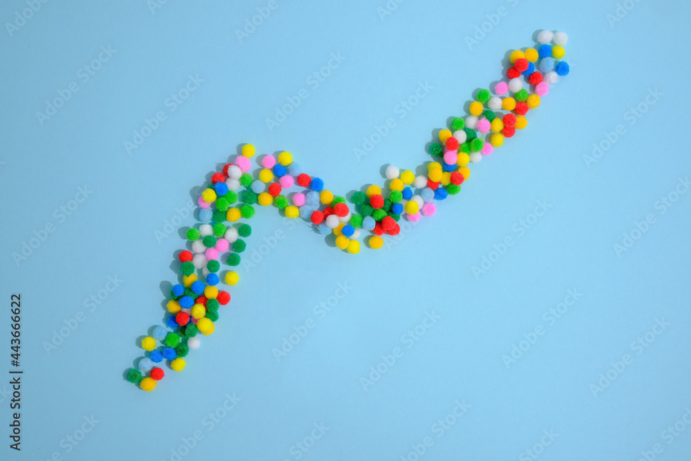 Arrow from rainbow balls on a blue background. Arrow from rainbow balls on a blue background.